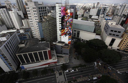 brazilian graffiti artist kobra puts the final touches to his piece of art in tribute to brazilian architect niemeyer next to his assistants at the financial center in sao paulo