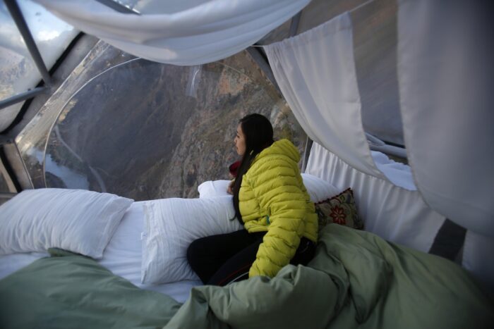 A guest looks the landscape inside a cabine at the Skylodge Adventure Suites in the Sacred Valley in Cuzco