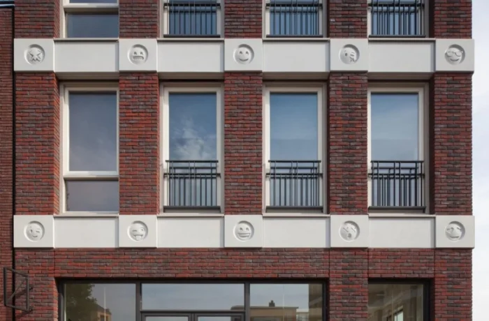 Dutch Architect Decorates Building Façade with Concrete Cast Emoji Instead of Gargoyles