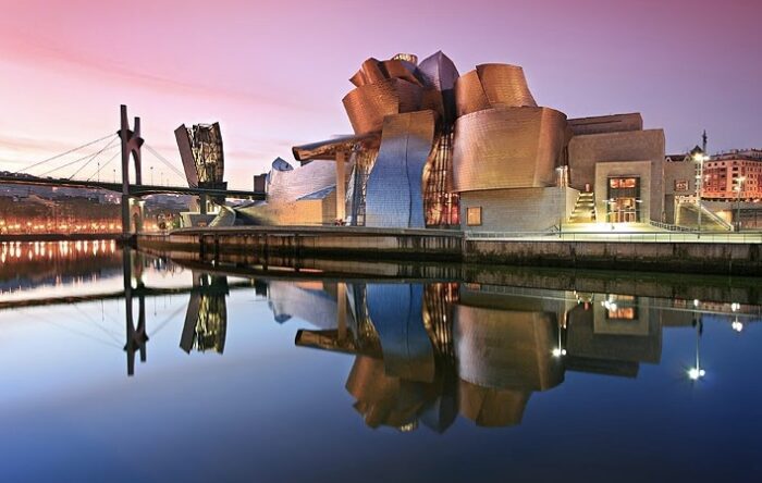 The Guggenheim Museum Bilbao by Frank Gehry, its curving titanium-clad volumes reflecting light above the Nervión River in Bilbao, Spain