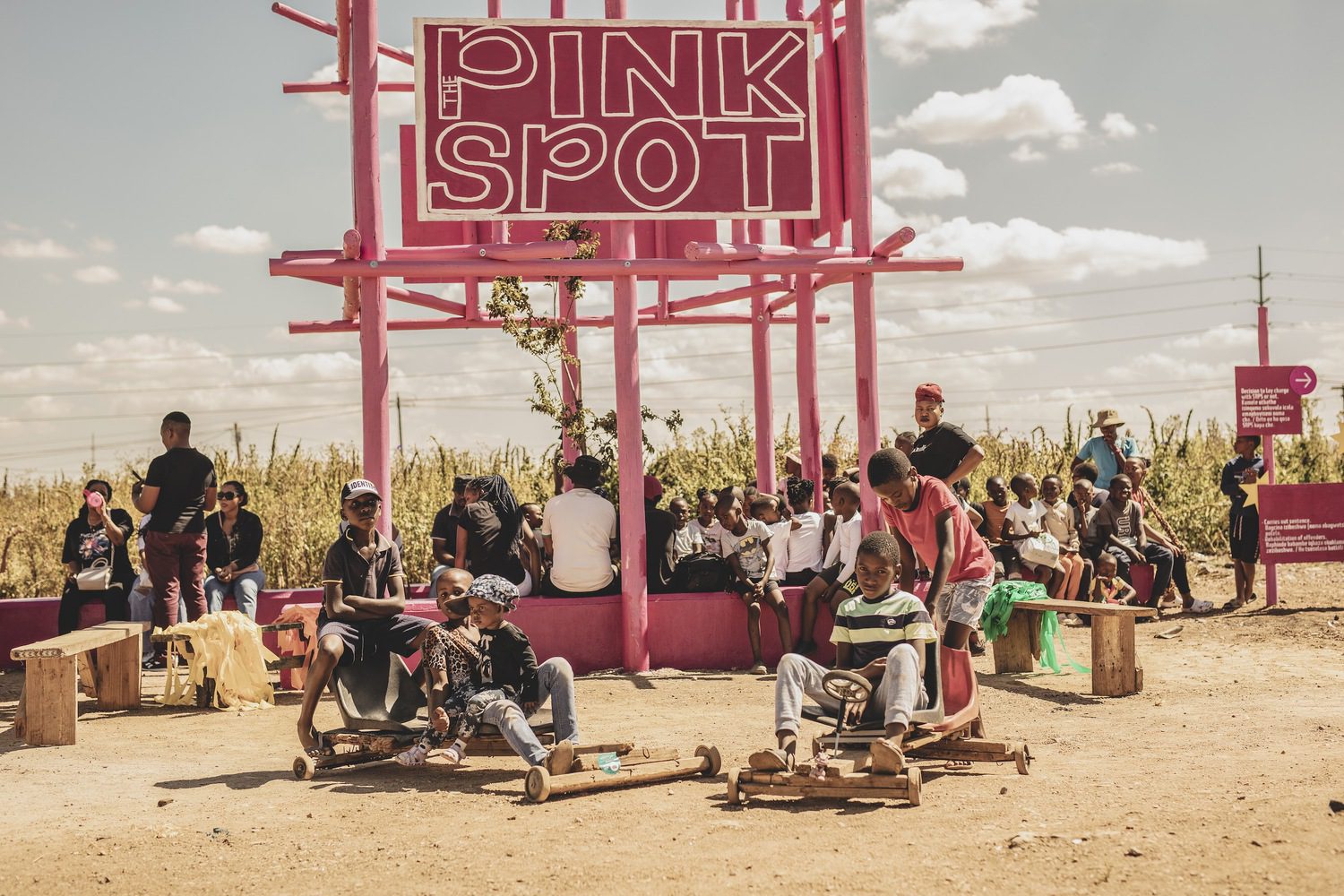 House of the Pink Spot with a bright pink architectural element in the landscape