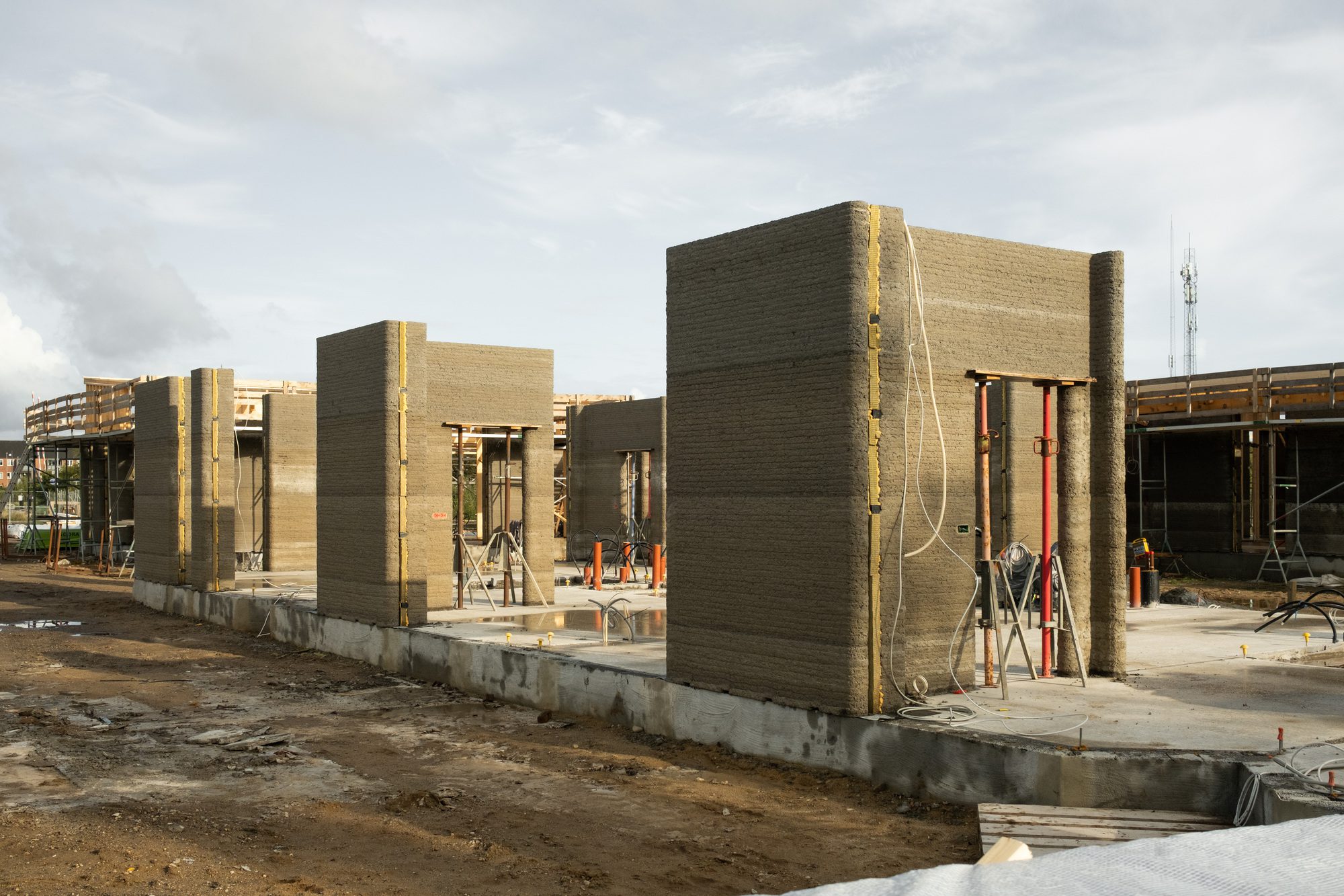 Courtyard between printed concrete student housing clusters with garden planting