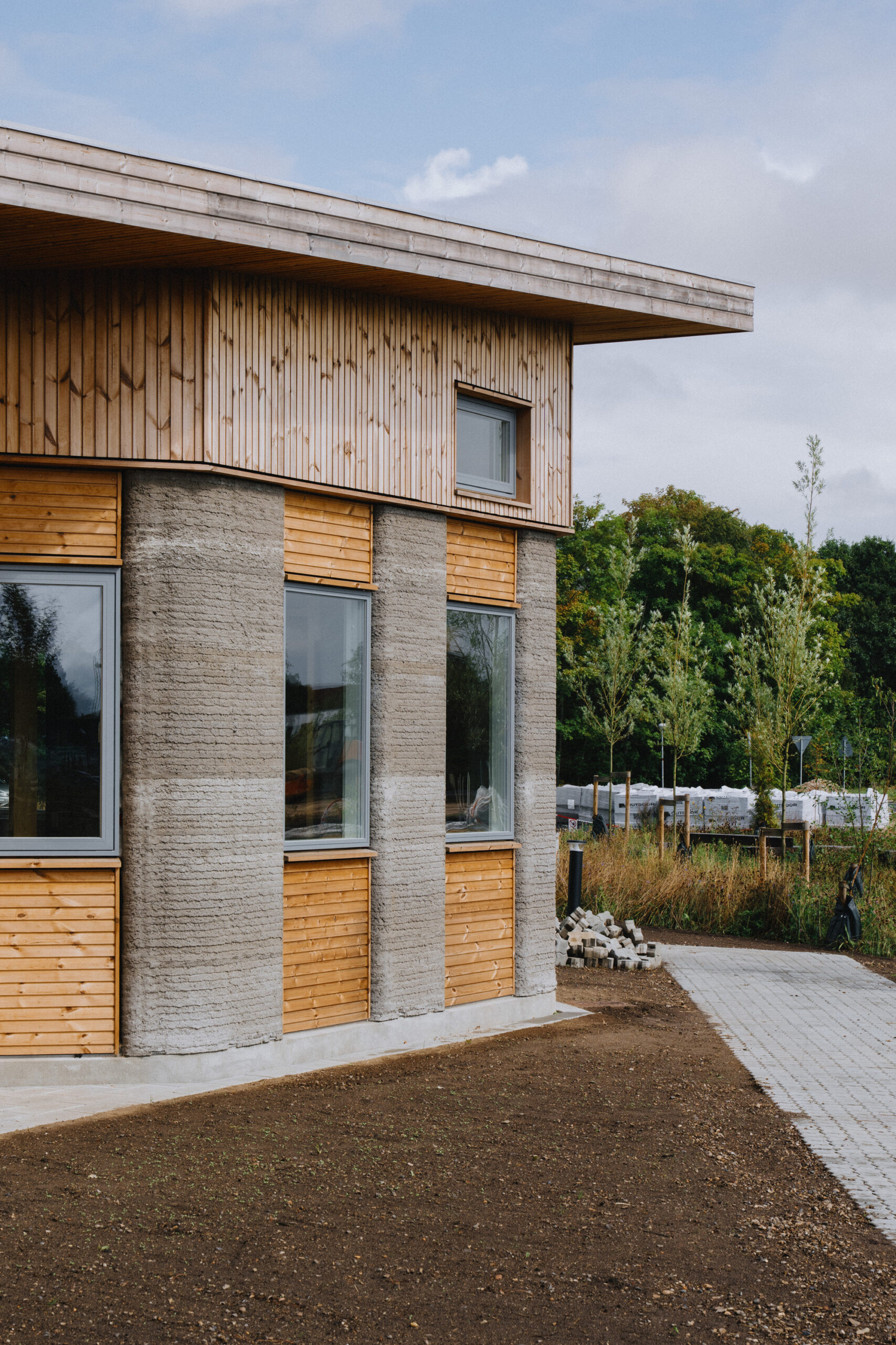 Row of printed concrete student apartments with entrances facing a shared path