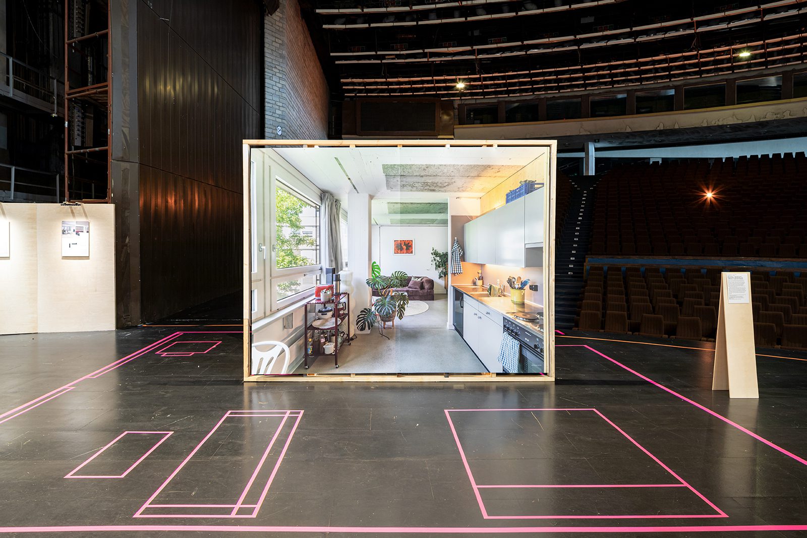 Visitors moving through curatorial displays inside the raw concrete Linnahall interior