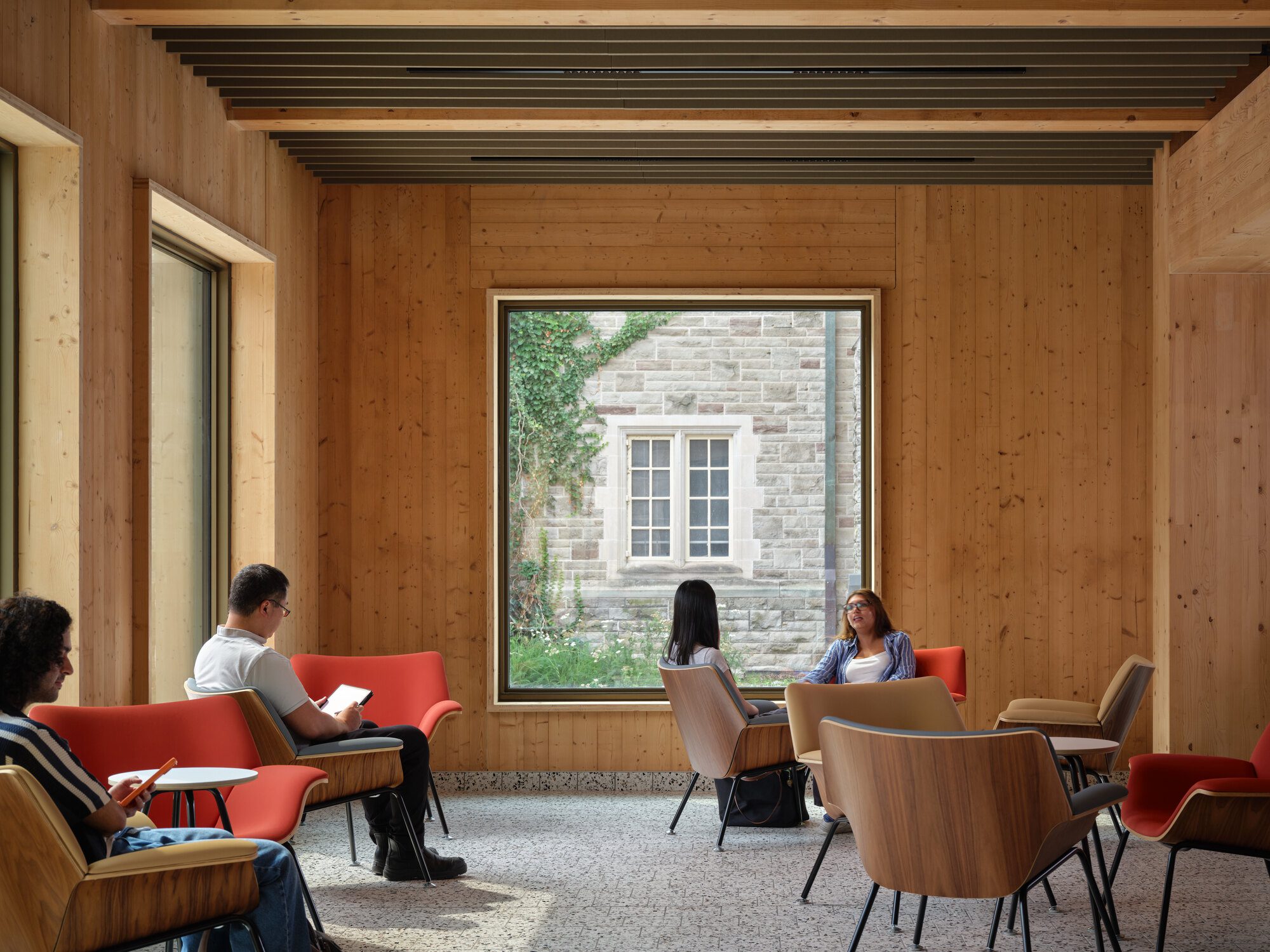 Lecture hall with exposed timber ceiling used for academic programming