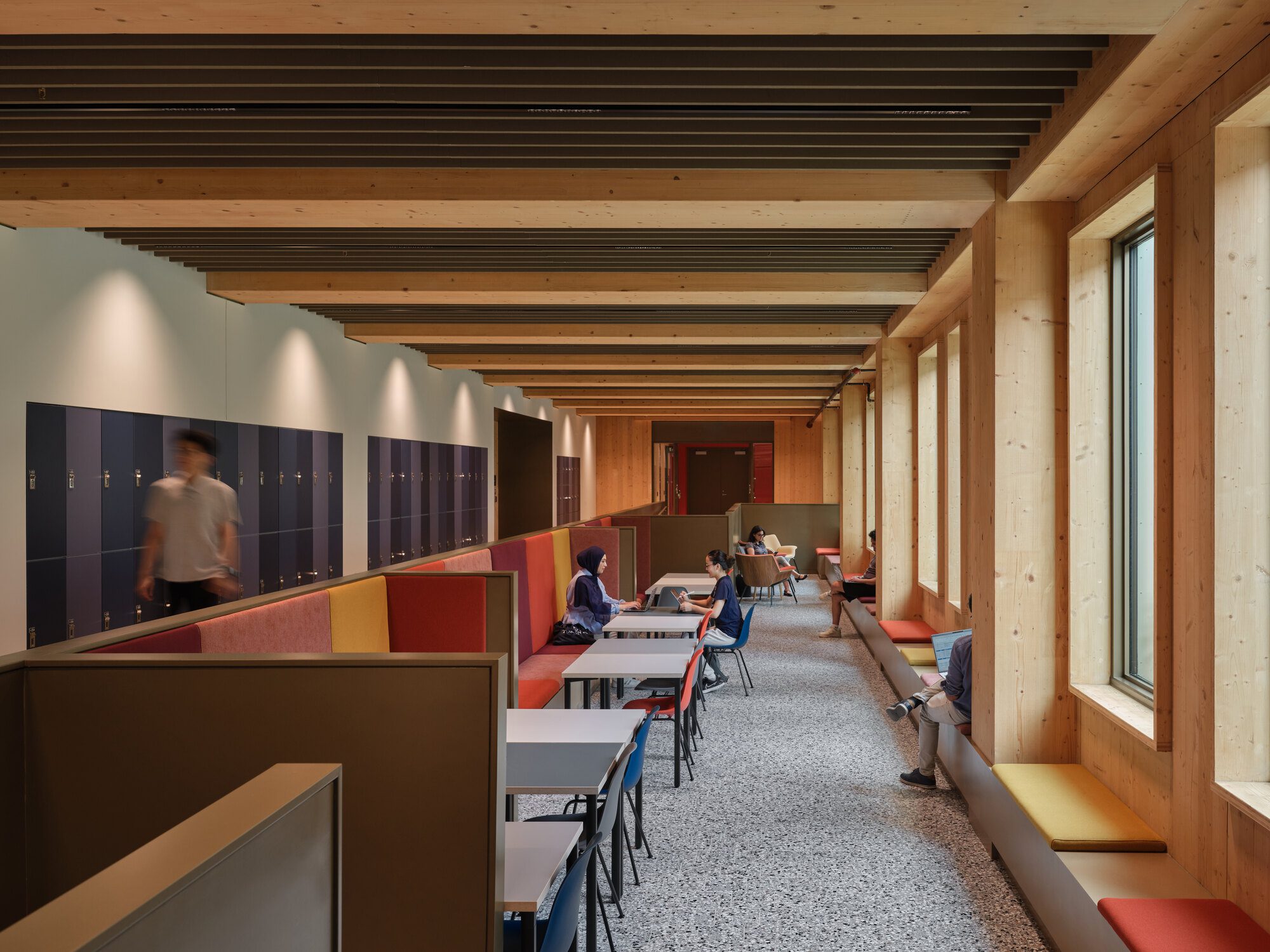 Open study space woven between offices and meeting rooms inside the building