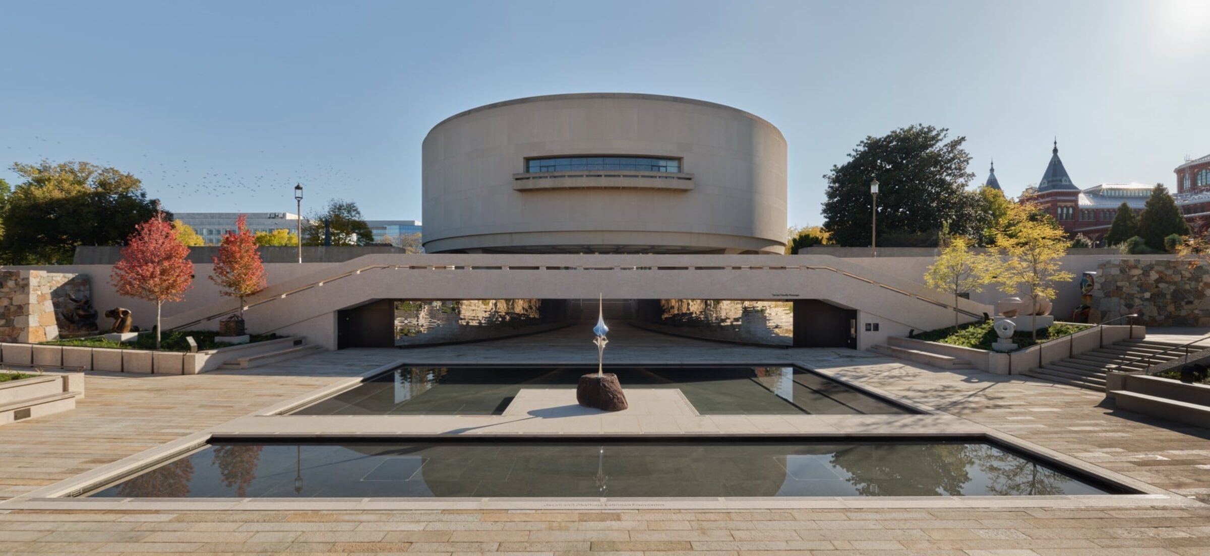 Stone-walled outdoor gallery with sculptures and new plantings in the Hirshhorn Sculpture Garden