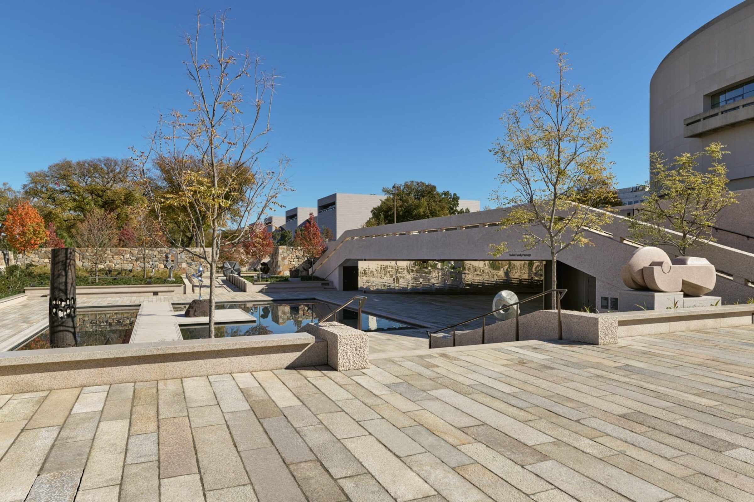 Visitors approaching sculptures along a path in the Hirshhorn Sculpture Garden redesign