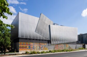 Crystal Substation facade with colorful ceramic tile base and folded aluminum panels above