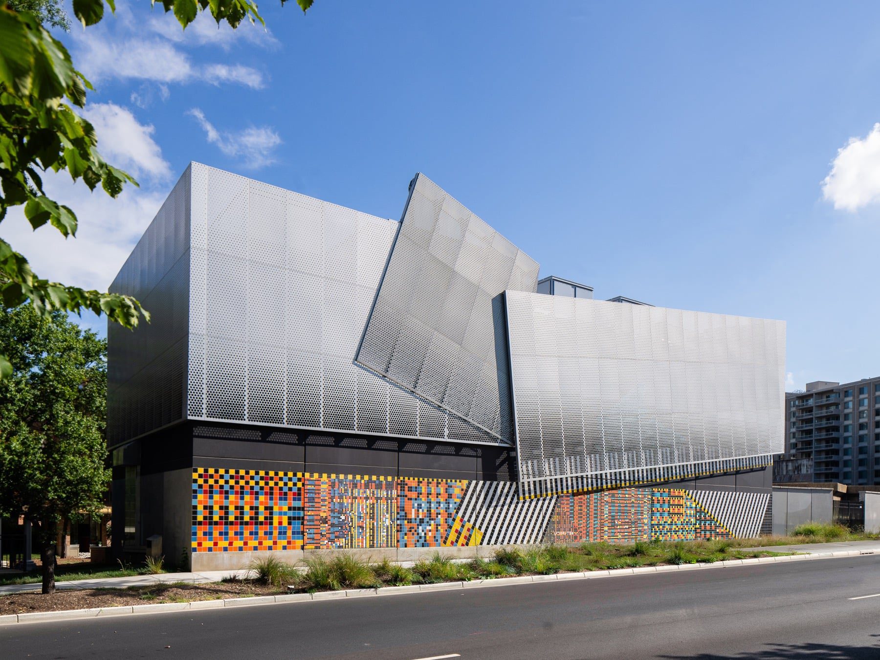Crystal Substation facade with colorful ceramic tile base and folded aluminum panels above