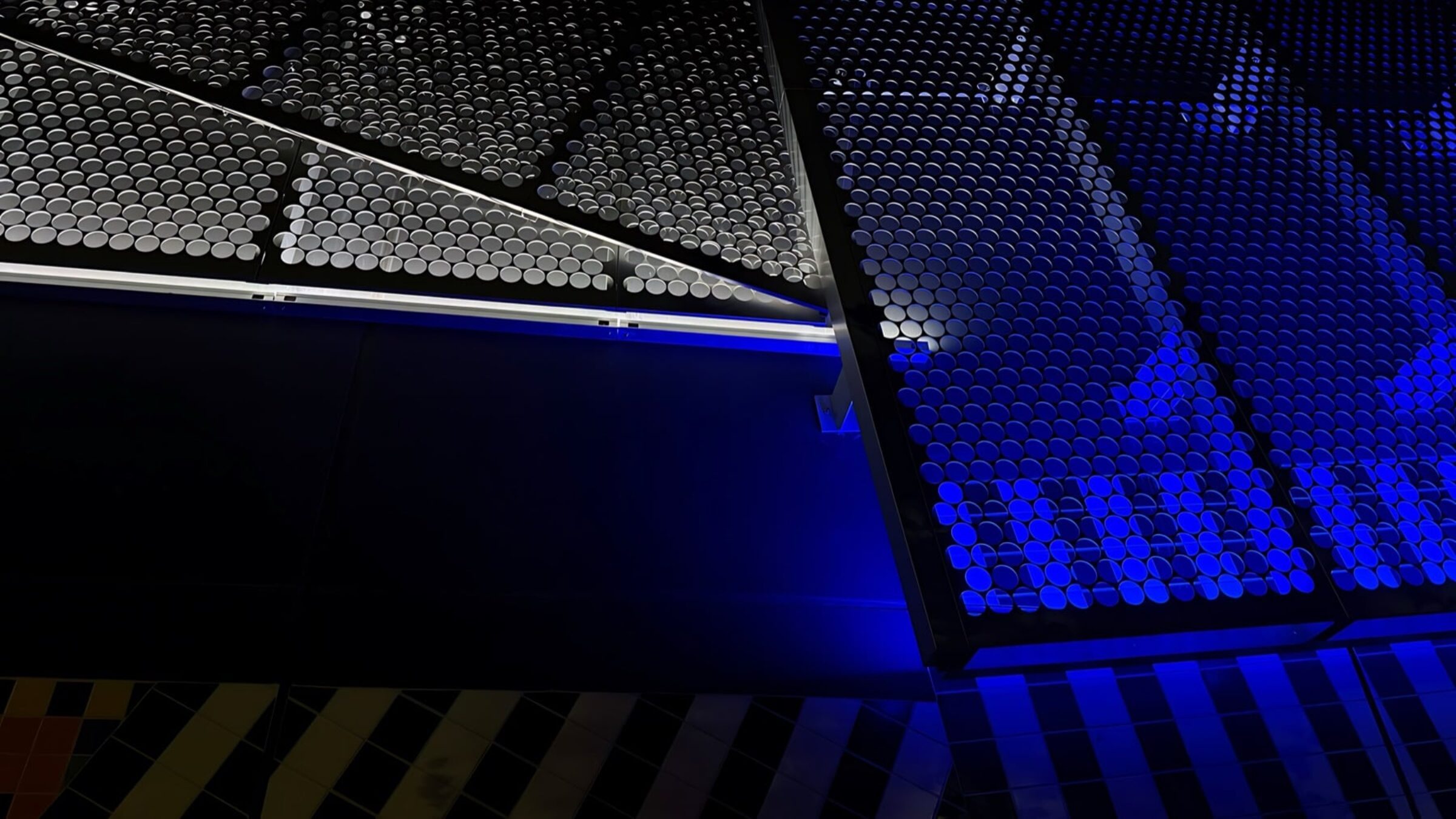 Evening view of the illuminated substation exterior showing color across the facade