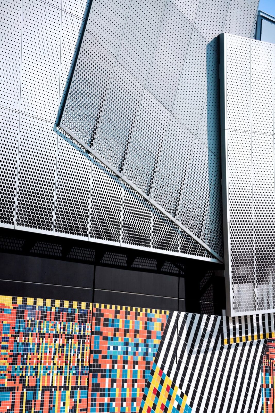 Substation exterior showing the contrast between tiled lower band and aluminum upper band