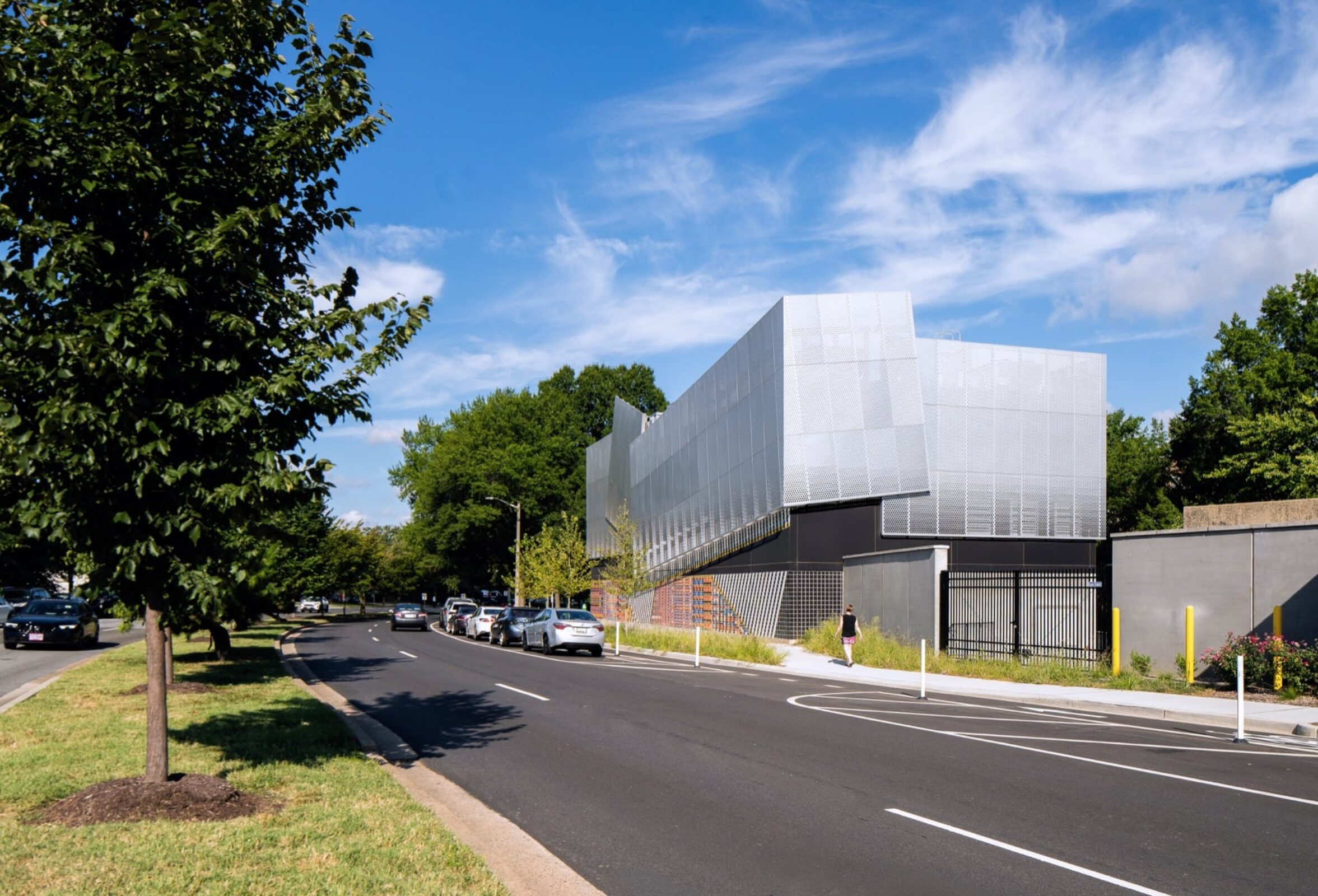 Shadows cast across the folded aluminum panels of the substation facade