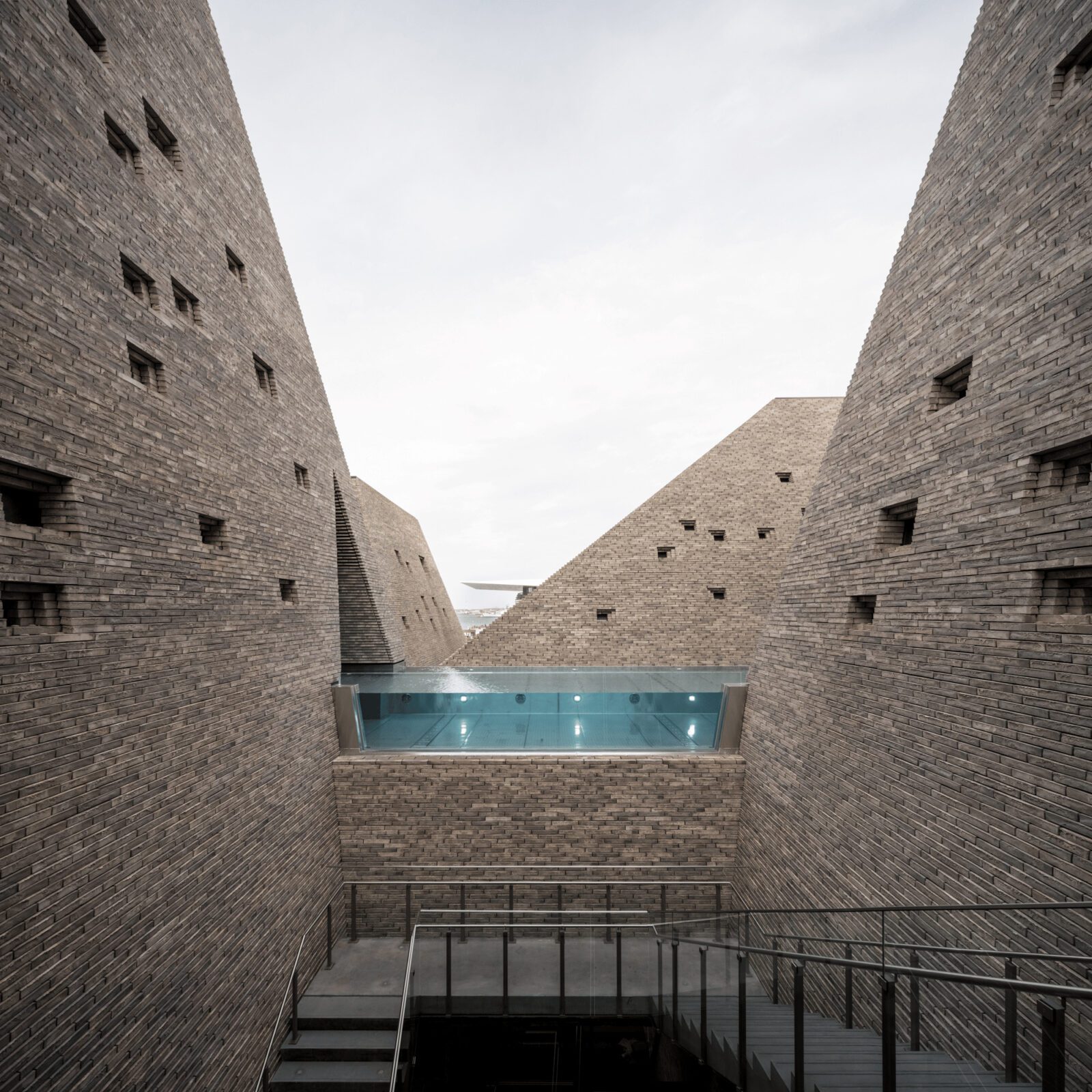 Handmade brick towers of the Water Culture House rising above the harbour waterfront
