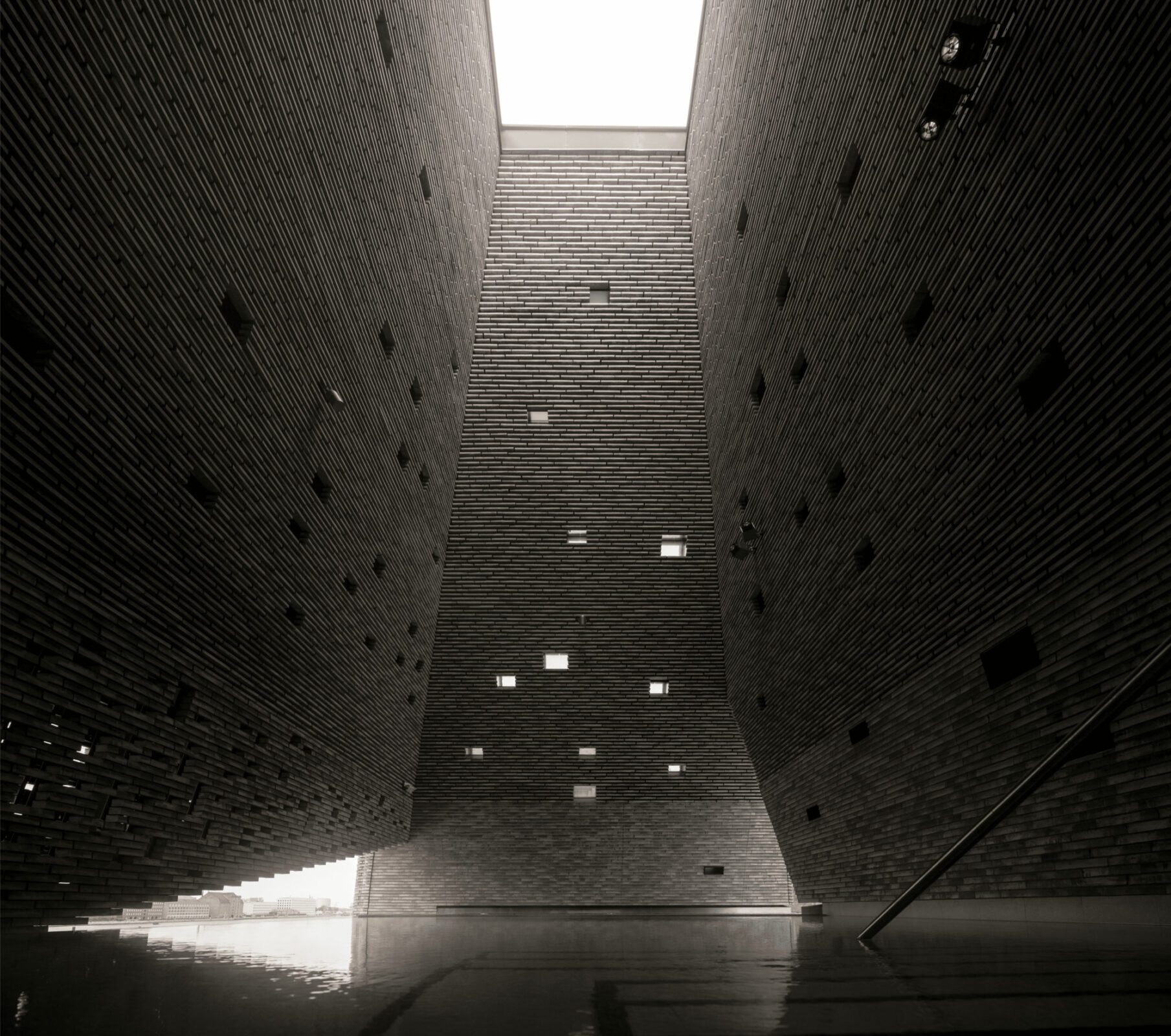 Glazed base of the Water Culture House framing views of Copenhagen Harbour