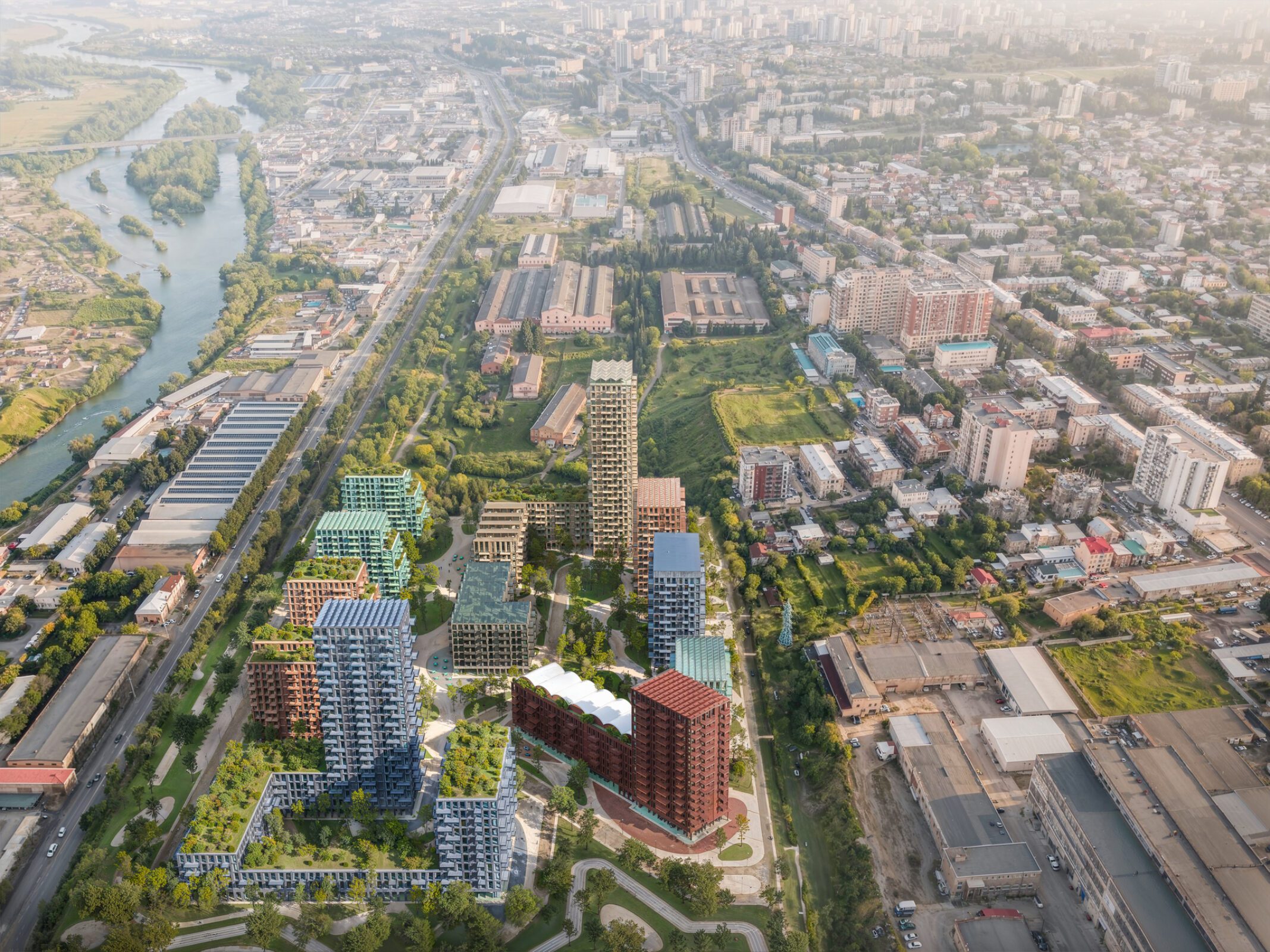 Aerial view of the Loco Park masterplan with brick buildings and green spaces in Tbilisi