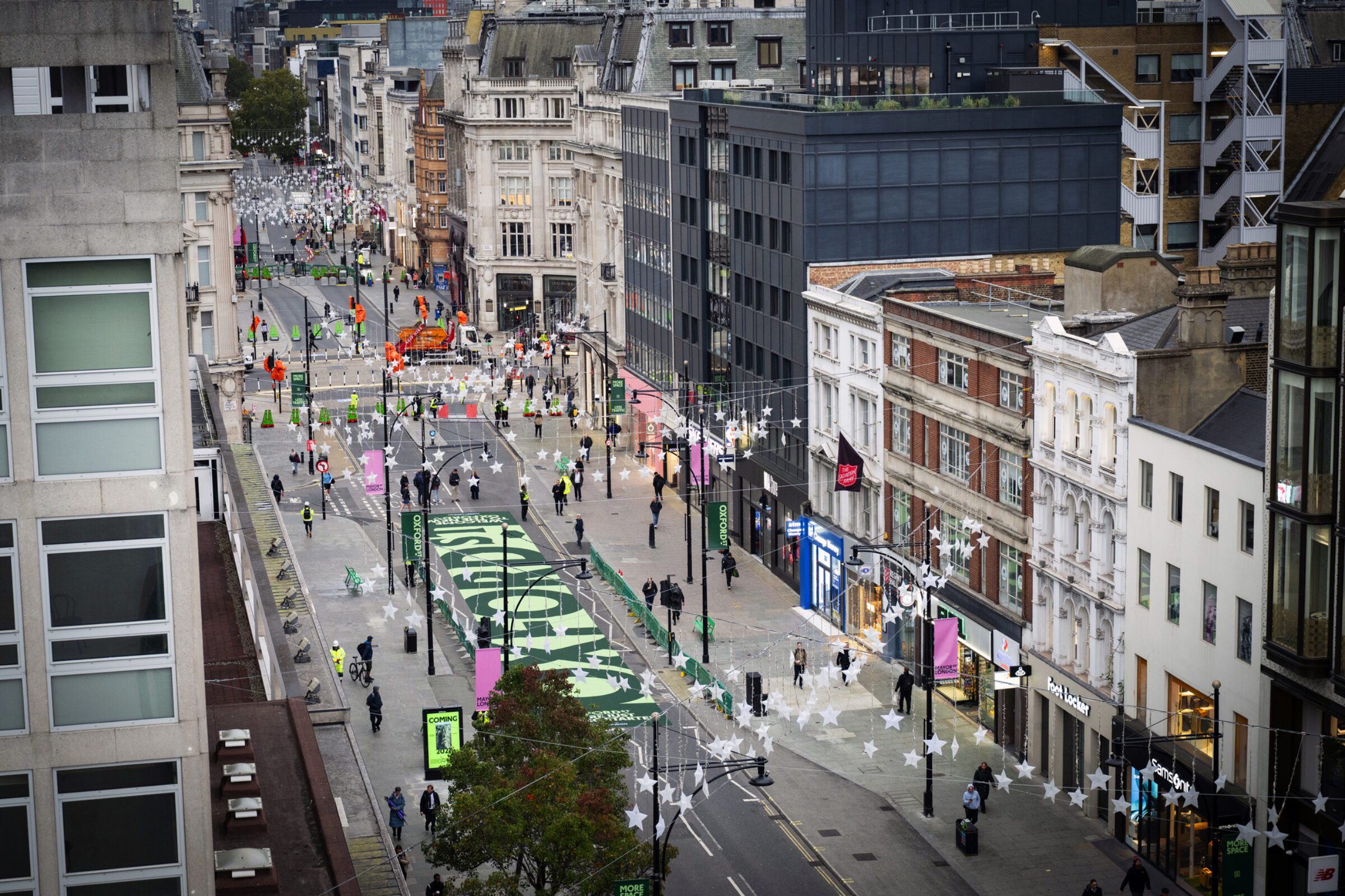 Pedestrians walking along the newly traffic-free first phase of Oxford Street in London
