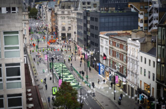 Pedestrians walking along the newly traffic-free first phase of Oxford Street in London