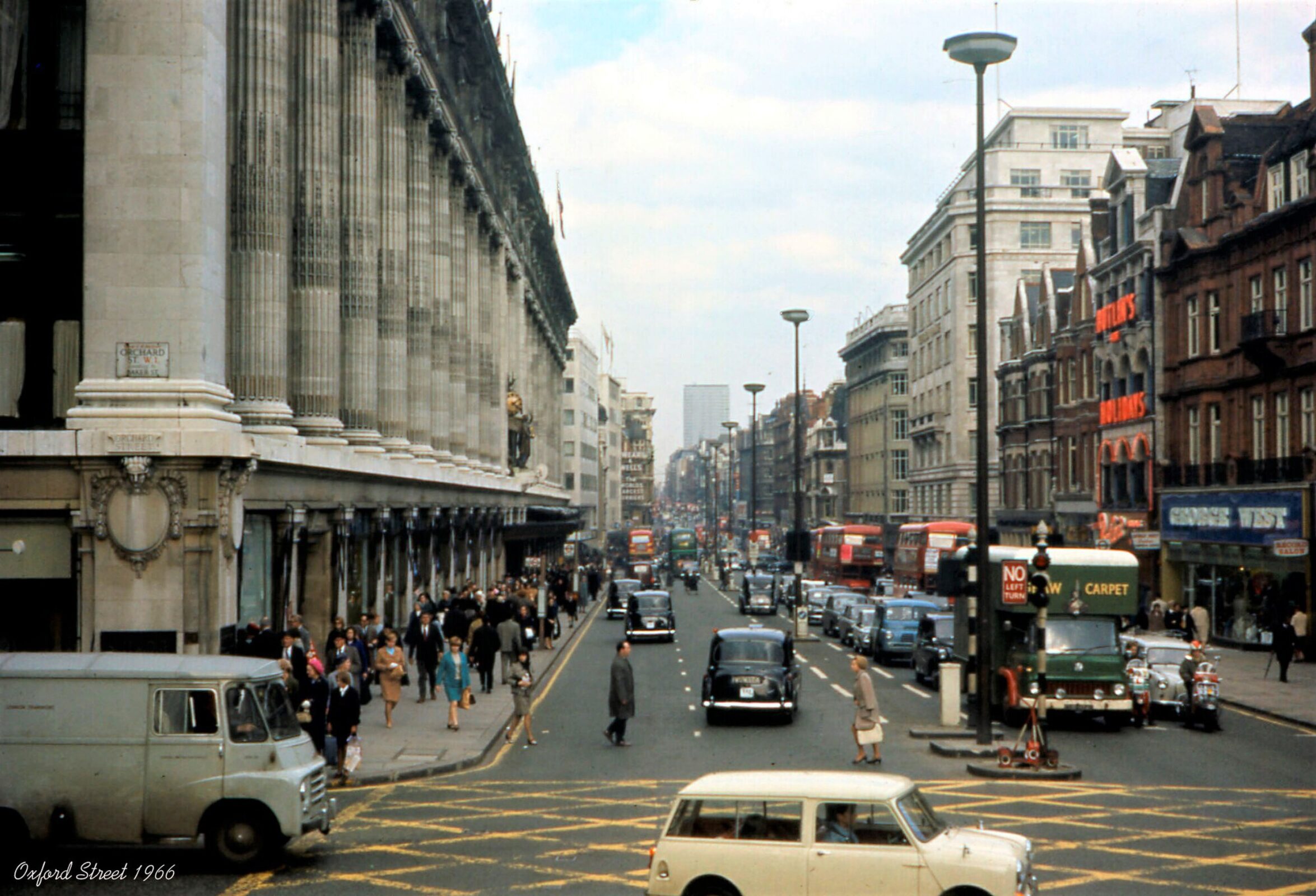 Dense crowds filling Oxford Street among shops and buses before pedestrianization, July 2013
