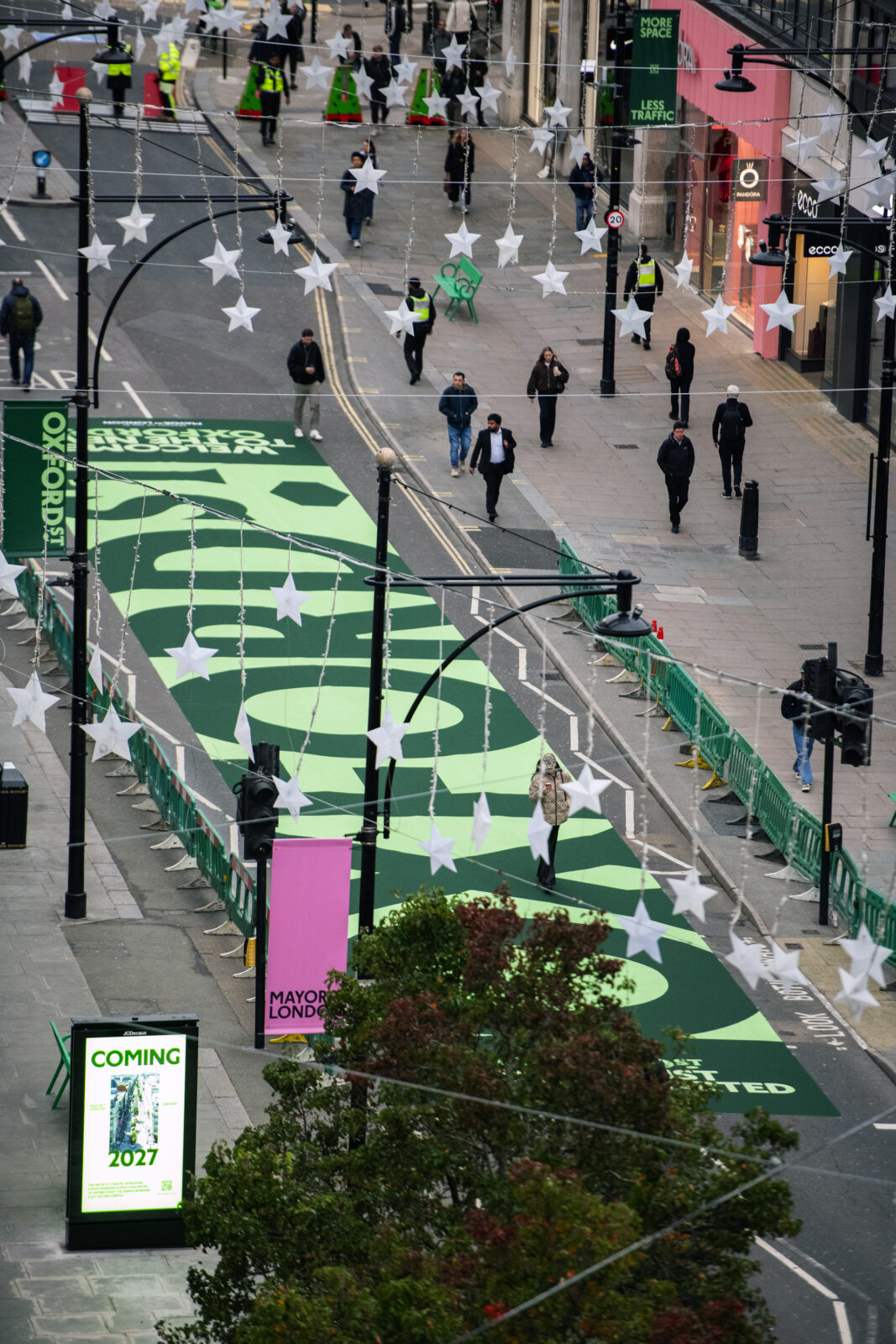Textured stone paving and timber seating along the pedestrianized stretch of Oxford Street