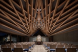 A radiating timber roof structure is displayed in a Buddhist temple in Japan
